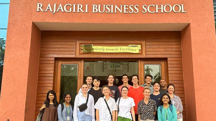 Staff and students from the UOWs Faculty of Business and Law standing in front of the Rajagiri Business School’s building